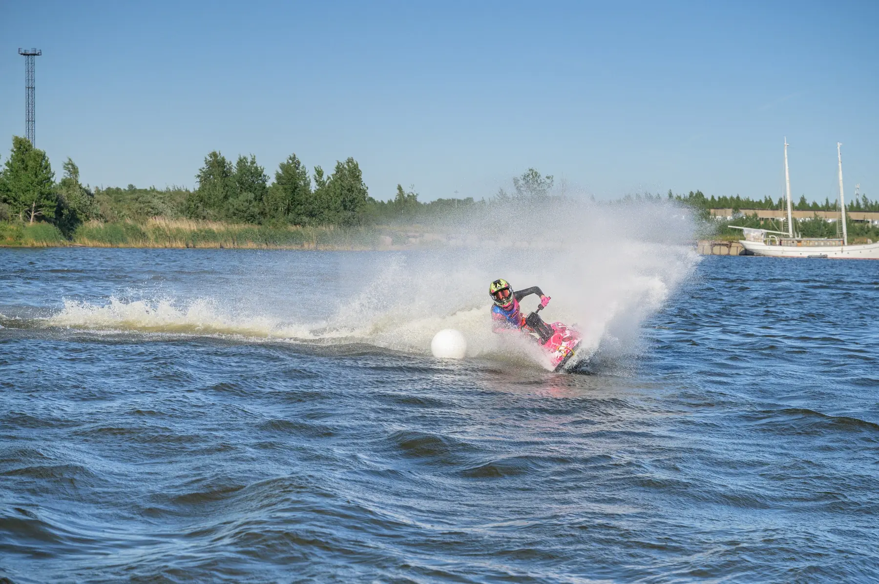 Eva rounds a buoy through a cloud of water spray