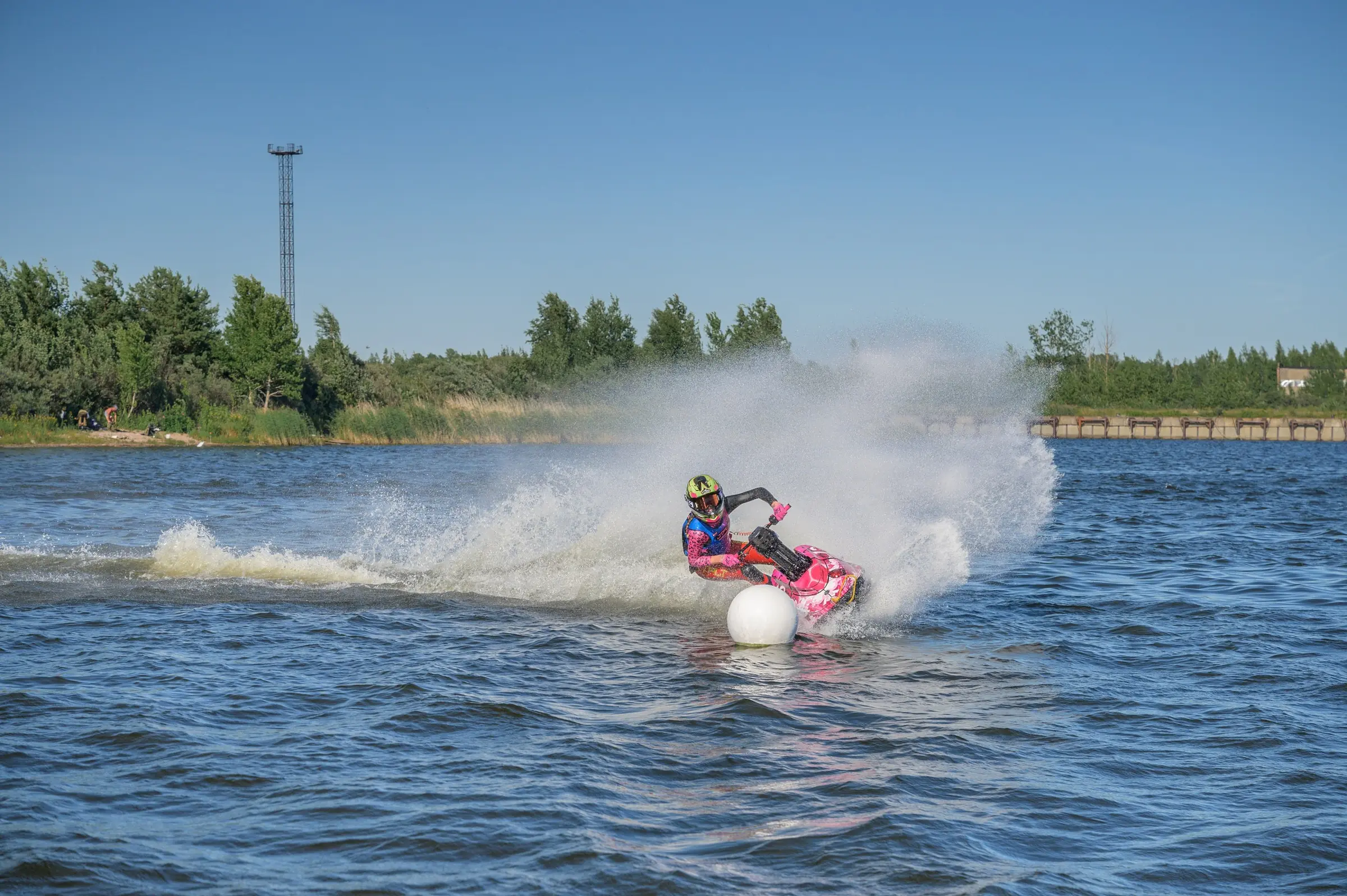 Eva rounds a buoy on her aquabike through a wall of spray